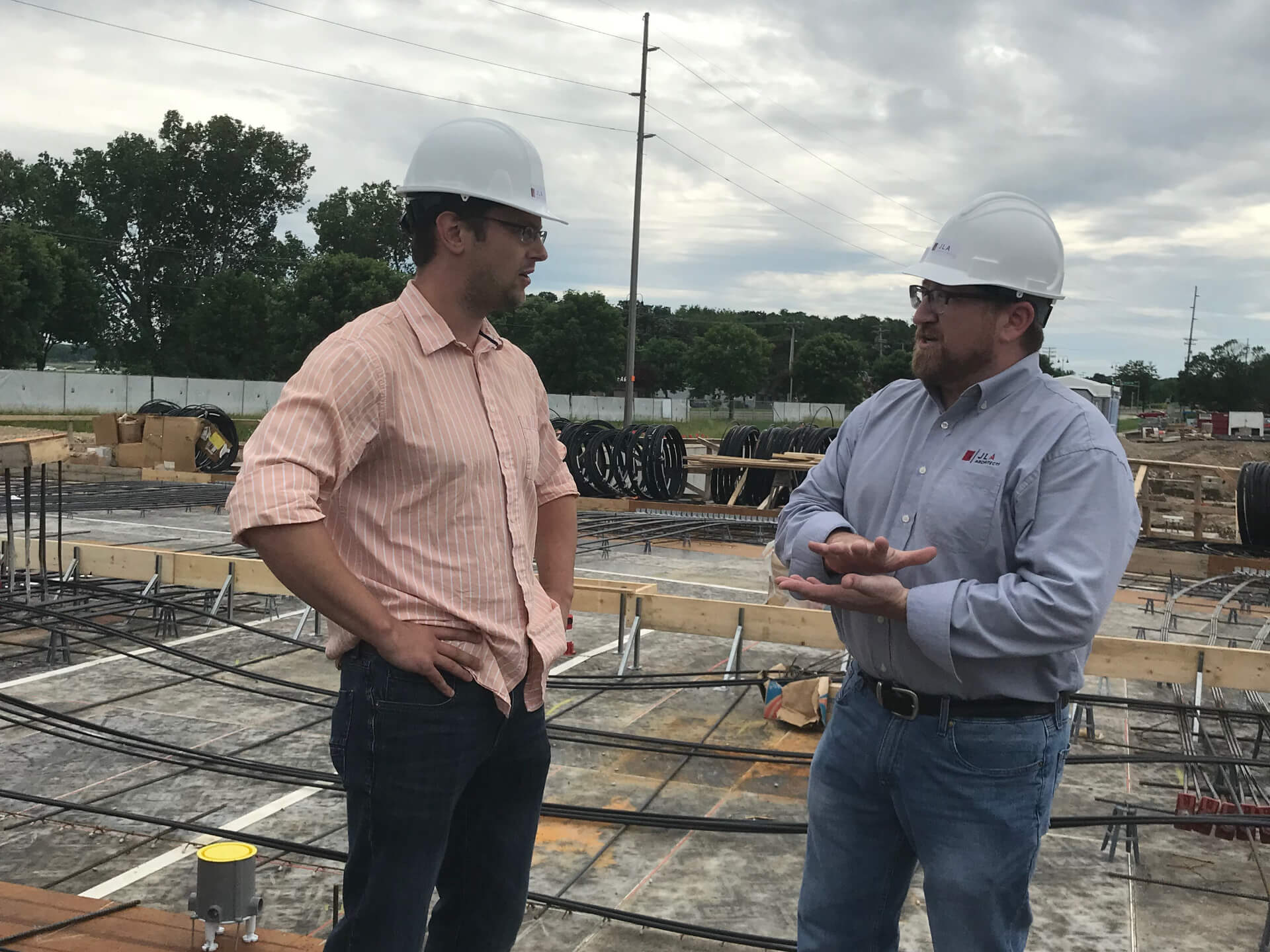 Adam on site at The Current with the client, Galway Companies.